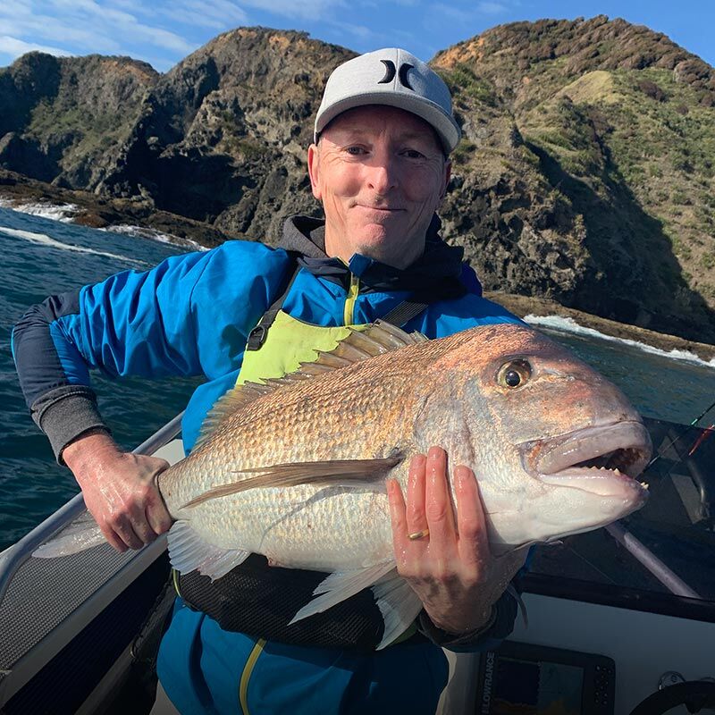 Rob Holloway Angle Tee owner holding a big snapper