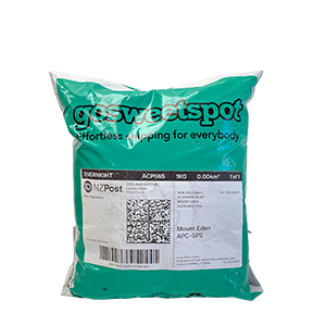 Green plastic shipping parcel containing Angle Tee printed apparel