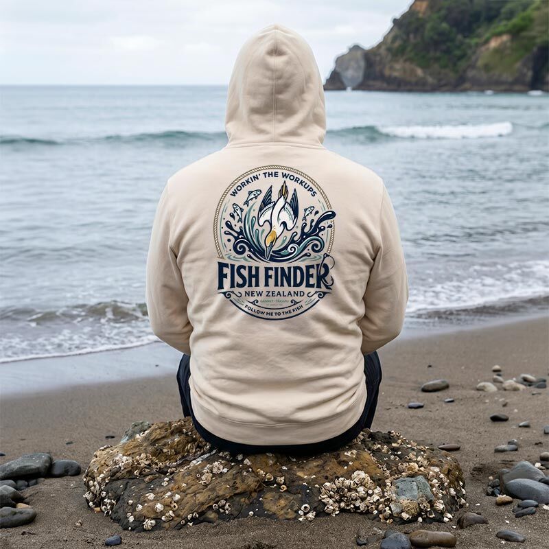 Back view of man sitting on a beach wearing Fishfinder NZ Gannet hoodie by Angle Tee